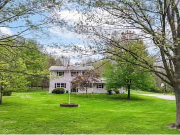 Charming two-story home with a lush green lawn and mature trees at 6113 N 250 E, Greenfield, IN 46140