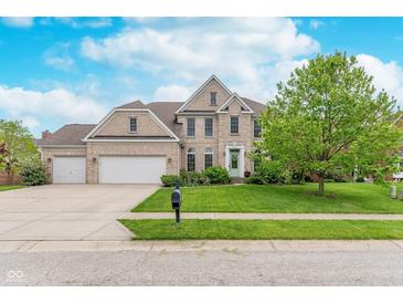 Charming two-story home featuring a brick facade, manicured lawn, and three-car garage at 8181 Fairway Dr, Brownsburg, IN 46112