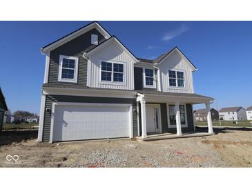 Charming two-story home featuring gray siding, a two-car garage, and a welcoming front porch at 10138 Redwood Peak Ln, Indianapolis, IN 46259