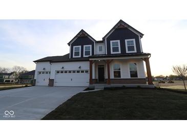Charming two-story home with a three-car garage and inviting front porch at 1114 Ridgevine Rd, Greenwood, IN 46143