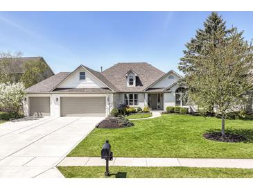 Charming single Gathering home with a well-manicured lawn and three-car garage, perfect for curb appeal at 11862 Stoney Bay Cir, Carmel, IN 46033