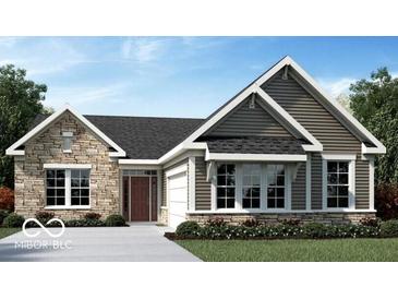 Charming single-story home featuring stone accents, dark siding, and a well-manicured lawn at 15053 Garden Mist Pl, Fishers, IN 46037