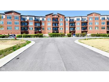 Attractive brick building with multiple stories and balconies on a sunny day at 20971 Shoreline Ct # 305, Noblesville, IN 46062