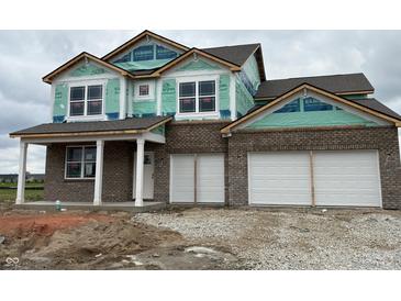 Under construction two-story brick home featuring an attached two car garage and covered porch at 210 Aster Way, Greenfield, IN 46140