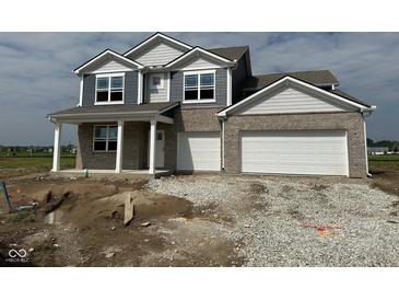 Inviting two-story home boasting a two-car garage and a covered front porch at 210 Aster Way, Greenfield, IN 46140