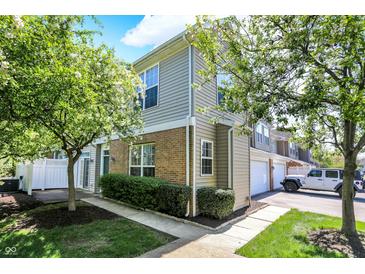 Charming townhouse featuring brick accents, manicured landscaping, and inviting curb appeal at 2270 Brightwell Pl, Indianapolis, IN 46260