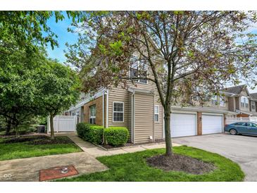 Charming townhome featuring vinyl siding, attached garage, and well-maintained landscaping at 2270 Brightwell Pl, Indianapolis, IN 46260