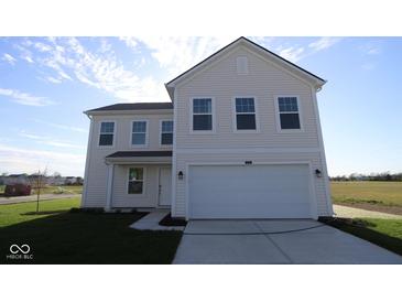 Charming two-story home featuring a two-car garage, well-maintained lawn, and classic architectural details at 3832 Highcrest Rd, Indianapolis, IN 46239