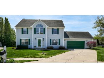 Charming two-story home with green garage door, manicured lawn, and beautiful landscaping at 4243 Bay Leaf Cir, Indianapolis, IN 46237