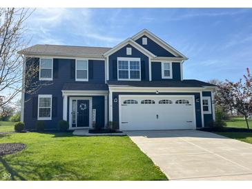 Two-story home with a two-car garage, dark siding, white trim, and a well-manicured lawn at 4245 W Fork Dr, Westfield, IN 46062