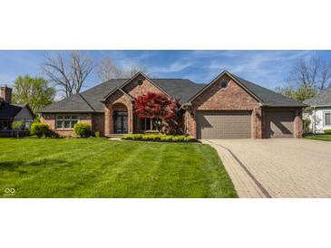 Charming brick home with manicured lawn, brick driveway, and two-car garage at 5872 Lake Kessler Ct, Indianapolis, IN 46226