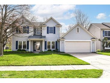 Charming two-story home with blue shutters, a well-manicured lawn, and an attached two-car garage at 6205 Albury Dr, Indianapolis, IN 46236