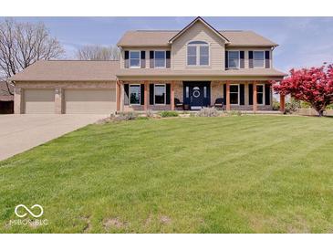 Charming two-story home featuring a manicured lawn and a welcoming front porch with wood columns at 6220 Yellow Birch Ct, Avon, IN 46123