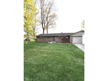 Charming brick ranch home with a well-manicured lawn and attached garage at 6226 Fairlane Dr, Indianapolis, IN 46259