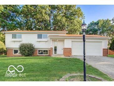Charming single-Gathering home with manicured lawn and mature trees adding curb appeal at 7206 Halden Pl, Indianapolis, IN 46214
