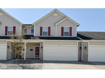 Inviting home featuring red shutters, a two-car garage, and manicured landscaping at 1175 Bent Tree Way, Plainfield, IN 46168