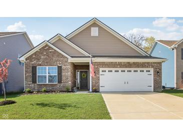 Charming single Gathering home with a brick facade, attached garage, and a well manicured front lawn at 122 Winding Brook Way, Pendleton, IN 46064