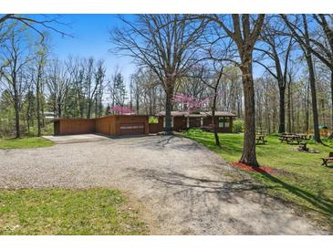 Charming single-story home featuring a spacious driveway, oversized garage, and a well-maintained lawn with mature trees at 16632 Oak Rd, Westfield, IN 46074