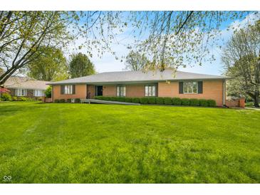 Charming brick home featuring a well-maintained lawn and manicured hedges at 273 N Serenity Way, Greenwood, IN 46142
