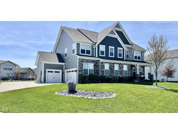 Beautiful two story home with manicured lawn, gray siding and stone facade with a two car garage at 4205 Hunt Club Pkwy, Bargersville, IN 46106