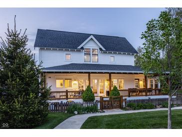 Charming two-story home features a spacious front porch, well-manicured lawn, and inviting curb appeal at 5682 Upper Garden Way, Zionsville, IN 46077