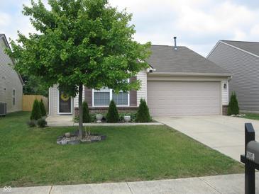 Charming home with a well-maintained lawn and a two-car garage at 6350 Emerald Springs Dr, Indianapolis, IN 46221