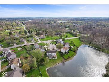 Scenic aerial shot of a neighborhood featuring well-maintained homes and a tranquil pond at 6514 Trevia Ct, Indianapolis, IN 46236