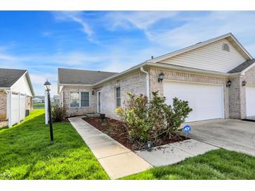 Charming brick townhouse with attached garage and well-manicured lawn and ADT security system at 793 Shepherds Way, Greenwood, IN 46143
