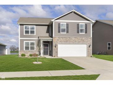 Charming two-story home with gray siding, stone accents, well-manicured lawn, and an attached two-car garage at 813 Sonoma Ln, Greenfield, IN 46140