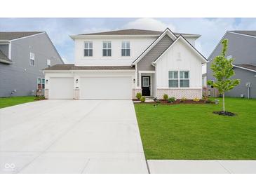 Charming two-story home with a well-manicured lawn and a spacious three-car garage at 8654 Tripp Rd, Pendleton, IN 46064