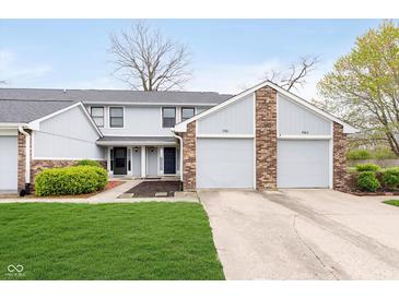 Charming townhouse with well-maintained lawn and attached two-car garage in a residential neighborhood at 9467 Sandpiper W Dr, Indianapolis, IN 46268