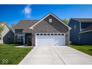 Charming home featuring a gray brick facade, a two-car garage, and a well-manicured lawn at 10538 Rose Mill Dr, Lawrence, IN 46235