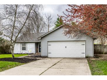 Charming single-story home with a well-maintained front yard and attached two-car garage at 106 W Delaware St, Fortville, IN 46040