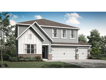 Charming two-story home with a three-car garage, stylish siding, and manicured landscaping at 10823 Soda Creek Ct, Indianapolis, IN 46239
