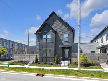 Modern two-story home featuring sleek dark siding and well-manicured landscaping at 1702 Alvord St, Indianapolis, IN 46202