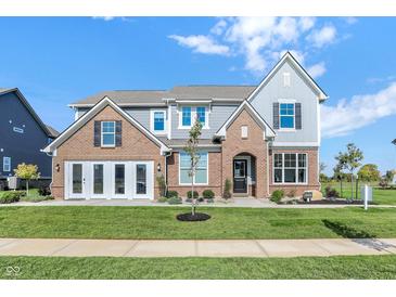 Stunning new construction home featuring brick accents, a manicured lawn and a charming covered entry way at 19472 Lewis Cir, Westfield, IN 46074