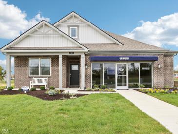 Charming model home featuring a brick facade, manicured lawn, and inviting entrance at 30 Benfield Dr, Whiteland, IN 46184