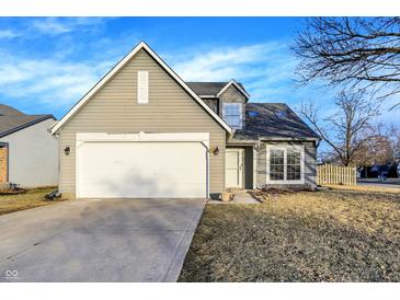 Charming home featuring a two-car garage, gray siding, and well-maintained landscaping at 5937 Terrytown Pkwy, Indianapolis, IN 46254