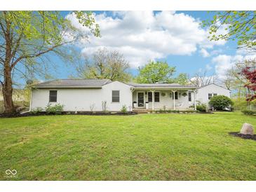 Charming one-story home featuring a large front yard, white siding, and inviting porch at 90 S Morgantown Rd, Greenwood, IN 46142
