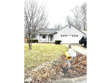 Charming one-story home featuring an attached two-car garage and well-maintained front lawn at 952 Delray Dr, Indianapolis, IN 46241
