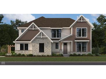 Two-story home showcasing stone and brown shingle accents, complemented by white siding and professional landscaping at 967 Apryl Dr, Greenwood, IN 46143