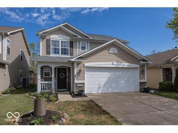 Charming two-story home with a two-car garage, landscaped yard, and inviting front porch with stone accents at 10208 Clear Sky Dr, Avon, IN 46123