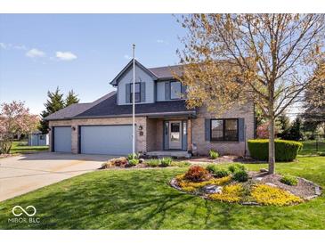 Charming two-story brick home with well-manicured lawn and mature landscaping at 10417 Mayapple Ct, Noblesville, IN 46060