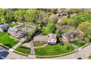 Aerial view showcases the home's prime location in a serene neighborhood with mature trees and well-kept lawns at 11626 Forest Dr, Carmel, IN 46033