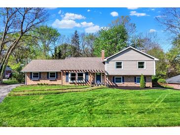 Charming two-story home with landscaped yard, blue shutters, and a well-manicured lawn at 11626 Forest Dr, Carmel, IN 46033
