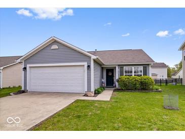Charming single-story home featuring a well-maintained lawn and an attached two-car garage at 123 Thistlewood Dr, Greenfield, IN 46140