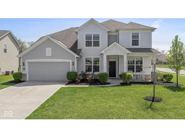 Charming two-story home with a well-manicured lawn and a two-car garage at 5635 Pennycress Dr, Noblesville, IN 46062