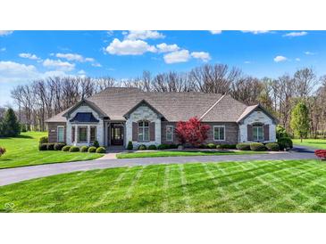 Sprawling single-story home with a well-manicured lawn and circular driveway at 6829 Whitetail Woods Ct, Bargersville, IN 46106