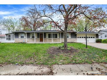Charming one-story home featuring a well-maintained lawn and a classic ranch-style facade at 7212 E Pleasant Run Pkwy S Dr, Indianapolis, IN 46219