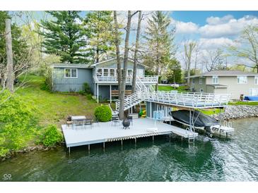 Aerial view of home featuring a white deck with a boat lift and a basketball hoop at 7456 Heather Ct, Nineveh, IN 46164